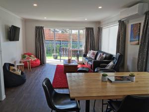 a living room with a couch and a table at Kerikeri Sunny Modern 2 Bedroom Apartments in Kerikeri