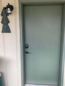 a door to a house with a sign on it at Elk Horn Lodge in Cooke City