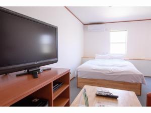 Кровать или кровати в номере Awajishima Hotel Lodge GREEN COZY
