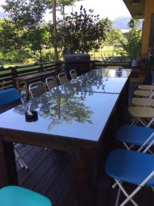 a bar with chairs and a table with trees on it at Lei Mi Er Hua Yuan Min Su in Pinghe