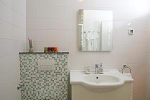 a bathroom with a sink and a mirror at Apartments Paola in Rovinj