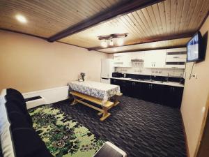 a kitchen with a table and a couch in a room at У Мар'яни in Vorokhta