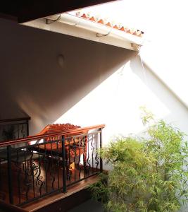a balcony with a table and a plant at Heeren Straits Hotel in Malacca
