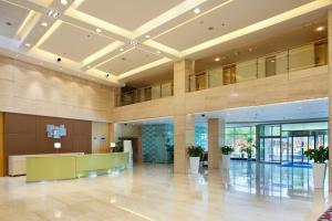 a lobby of a building with a reception desk at Holiday Inn Express Tianjin Airport, an IHG Hotel in Tianjin