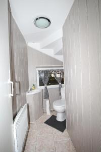 a bathroom with a toilet and a tub and a sink at LA MEDINA in La Fère
