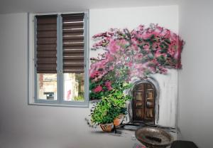 a painting of a door and flowers next to a window at LA MEDINA in La Fère