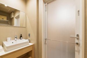 a bathroom with a sink and a shower at GRAND BASE Hakatamon in Fukuoka +29 photos