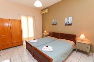 a bedroom with two beds with towels on them at Angela in Loutra Edipsou