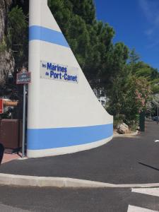 a building with a sign on the side of a street at Magnifique T2 au calme avec une superbe vue sur le port in Canet-en-Roussillon