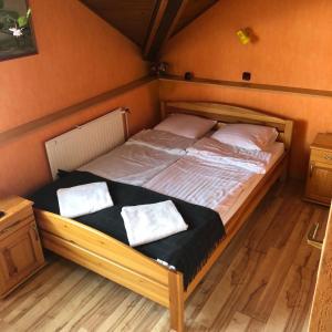 a bed with two pillows on it in a room at U Pauli i Eryka in Łeba