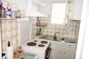 a small kitchen with a sink and a stove at Nea Styra seafront apartment with stunning view in Nea Stira