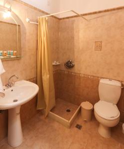 a bathroom with a toilet and a sink and a shower at Angela in Loutra Edipsou +57 photos