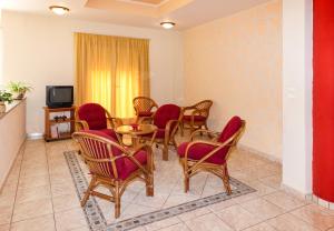 a room with a table and chairs and a tv at Angela in Loutra Edipsou