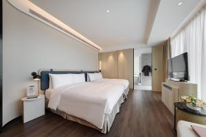 Ένα ή περισσότερα κρεβάτια σε δωμάτιο στο Jasper Young Hotel Banqiao