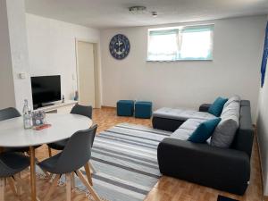 a living room with a couch and a table at Stiller Hafen in Herbolzheim