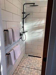 a bathroom with white towels and a shower at Sorrento Back Beach Apartment at Oceanic Apt 7 in Sorrento +47 photos