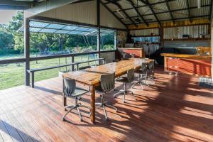 a wooden table and chairs on a wooden deck at Studio 165 Hidden Gem on 50 acres with bay views in Grantville