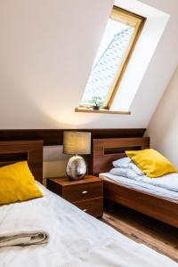 Posteľ alebo postele v izbe v ubytovaní Apartamenty Stroma Odkryj Zakopane