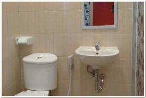 a bathroom with a toilet and a sink at RedDoorz @ Sindangbarang Bogor in Bogor