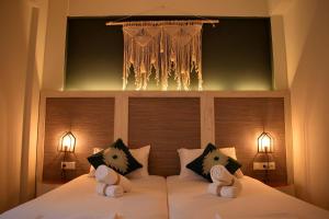 a bedroom with a large bed with two pillows at Pasithea in Frangokastello