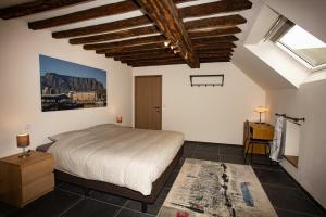 a bedroom with a large bed and a window at B&B Hotel Ferme des Templiers nabij Durbuy, eigen laadpalen in Somme-Leuze