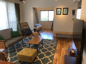 a living room with a couch and a table at FUSHIME in Motobu +83 photos
