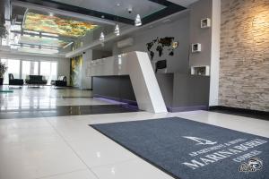 an office with a lobby with a welcome mat on the floor at Apartamenty RÓŻA WIATRÓW - MARINA BORKI in Augustów