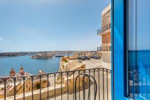 a view of the water from a balcony at Valletta Harbour View Apartment in Valletta