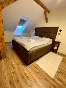 a bedroom with a bed with a wooden floor at VILLA ANGEL in Rožňava