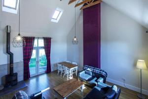 a living room with a couch and a table at Borthwick Castle View in North Middleton
