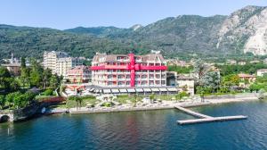 a large red building in the middle of a body of water at Hotel Splendid in Baveno