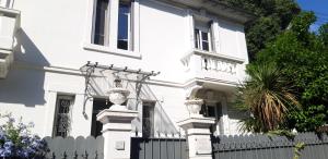 a white house with a white picket fence at Villa Angelus in Nice
