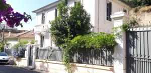 a white house with a black fence at Villa Angelus in Nice