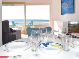 a table with glasses and a bowl on top of it at Apartament Blue Lloret de mar in Lloret de Mar