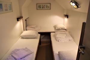 a small room with three beds and a desk at Felicitas in Amsterdam
