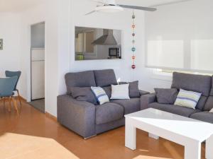 a living room with a couch and a table at Apartament Blue Lloret de mar in Lloret de Mar