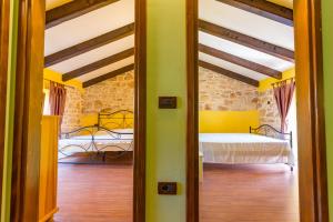 an open door to a bedroom with a bed at Casa Ghedda in Gedići