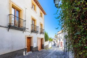 an empty street in an alley with buildings at Genteel Home Alhacaba in Granada