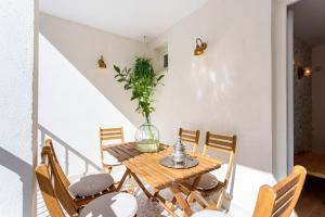 a dining room with a wooden table and chairs at Genteel Home Alhacaba in Granada