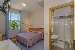 Postel nebo postele na pokoji v ubytování Hotel Sogno