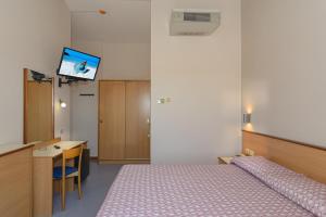 Postel nebo postele na pokoji v ubytování Hotel Sogno