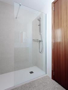 a shower with a glass door in a bathroom at Hostal Vila del Mar in Lloret de Mar