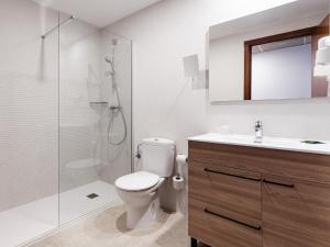 a bathroom with a toilet and a shower and a sink at Hostal Vila del Mar in Lloret de Mar
