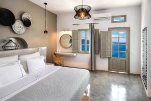 Postel nebo postele na pokoji v ubytování Kaleidoscope Oia Suites