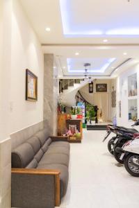 a waiting room with a couch and motorcycles in it at Aqua Nhu Huynh Hotel in Ho Chi Minh City
