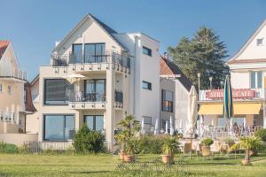 a large white building with a lawn in front of it at Ferienwohnung Montfort in Langenargen