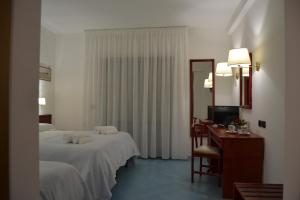 Postel nebo postele na pokoji v ubytování Tafuri Hotel
