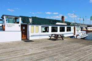 a boat with a picnic table on a dock at Passengership Avanti in Amsterdam