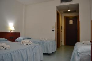 Postel nebo postele na pokoji v ubytování Tafuri Hotel