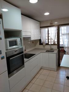 Kuchyň nebo kuchyňský kout v ubytování Apartamentos Playa